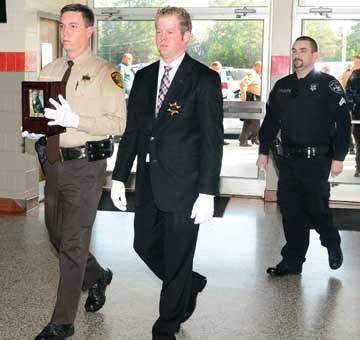 Reserve Officers Charles Childress and Zach Chapple escort Gorky’s remains into the service, followed by Cpl. Chris Fleming.