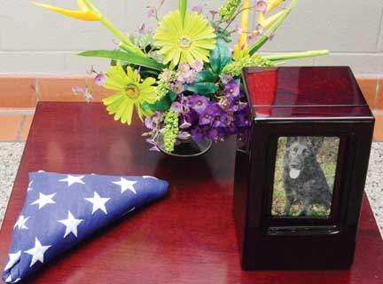 Flowers and an American flag flown over the US Capitol and presented by Rep. Virginia Foxx accompany Gorky’s remains.